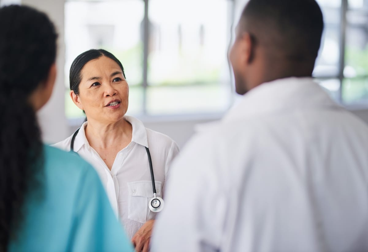 Three clinicians debriefing after a process